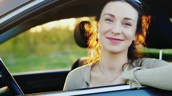 Attractive Woman Looks Out the Car Window Portrait