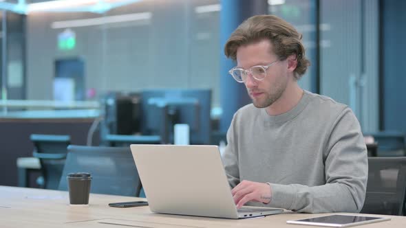 Yes Gesture By Head Shake By Young Businessman at Work