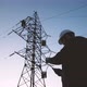 A Construction Engineer Power Engineer in a Protective Helmet Checks the Poles of Power Lines - VideoHive Item for Sale
