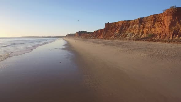 Aerial Flight Over a Beautiful Evening Beach at Low Tide and a Mirrored Surface That Reflects the