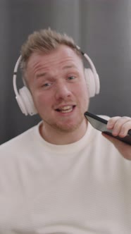 Vertical Close Up of Man in Headphones Singing