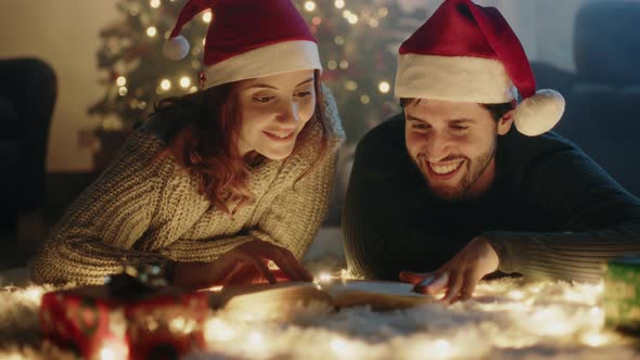 Couple reads book at Christmas