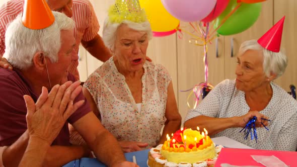 Senior woman celebrating her birthday with friends