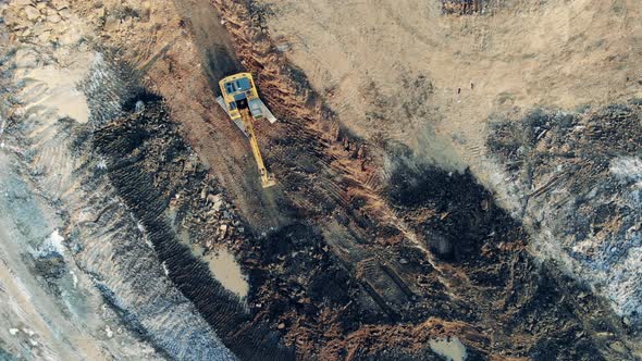 Construction Excavator Works at a Career Moving Sand