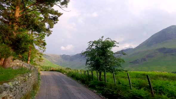 Driving through a small road in the Lake District at sunset, England