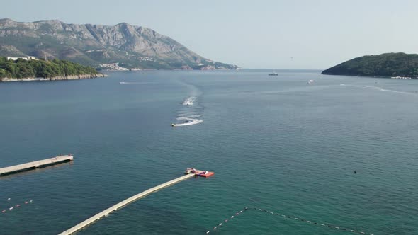 Aerial View of the Resort Sea Beach with Boats and Jet Skis in Budva Montenegro