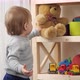 Baby boy taking teddy bear toy from bookshelf - VideoHive Item for Sale