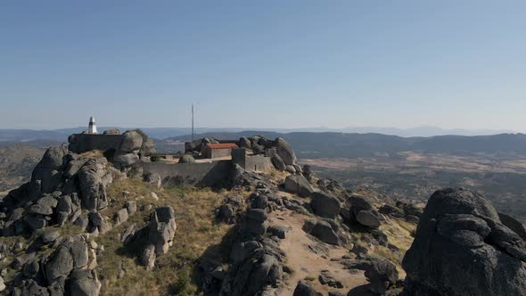 Aerial drone approach of ancient Monsanto hilltop castle in Portugal