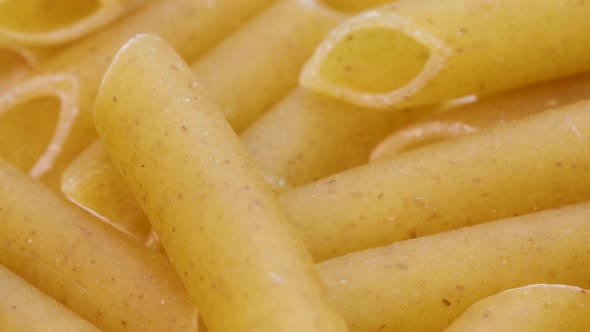 Detail shot of healthy wheat pasta, italian macaroni, macro shot in 4k. Rotating motion, view from a