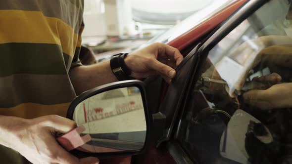 Hands of Car Mechanic in Auto Repair Garage Service