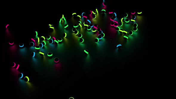 Many black children toy balls with neon lights falling on the floor
