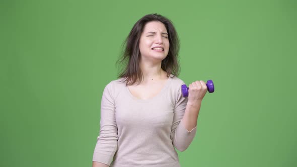 Young Beautiful Woman Exercising with Dumbbells