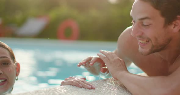 Woman and Man Smiling Near Swimming Pool Water