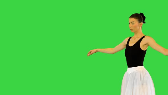 Young Ballerina Walks Demipointe Performing Some Ballet Movements on a Green Screen Chroma Key