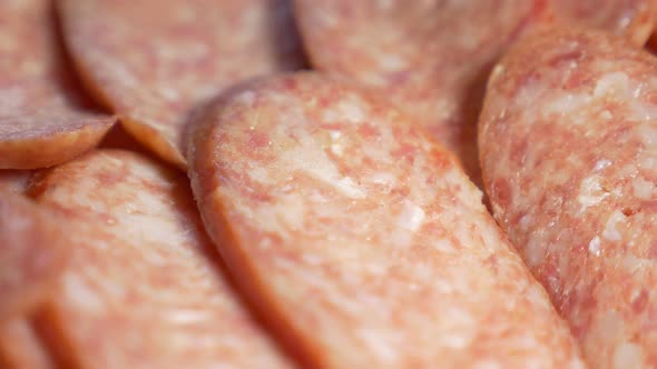 Pan over pork salami slices in UHD 3840X2160 footage - Salami pan shallow DOF 4K UHD video