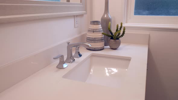 Slide right along a newly remodeled white bathroom vanity with sink and interior decor.