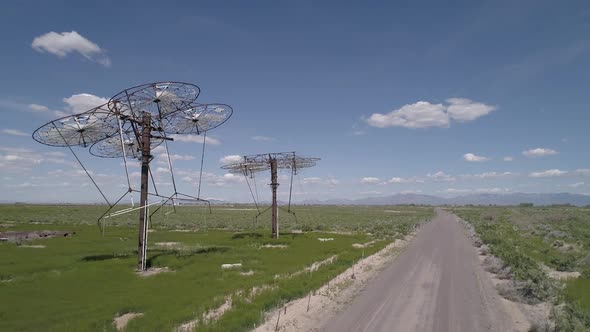 Flying over dirt road next to solar power plant in Utah