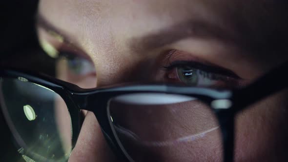 Woman in Glasses Looking on the Monitor and Surfing Internet