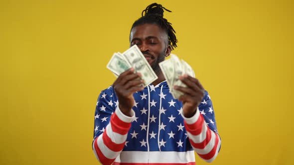 Excited Rich African American Smiling Man Dancing at Yellow Background Smiling