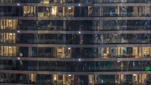 Outside View of Windows in Apartments of a High Class Building at Night Timelapse