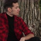 A Man Sits Outside By a Tree - VideoHive Item for Sale
