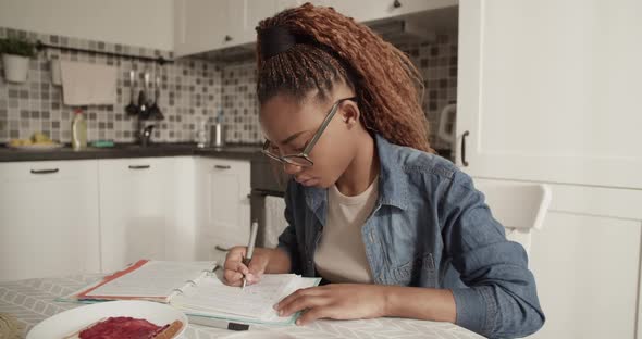 African American Student Doing Homework Near Toast