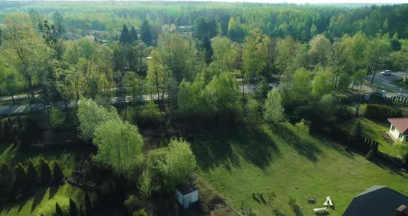 Drone point of view of a housing estate in the suburbs surrounded by forest.