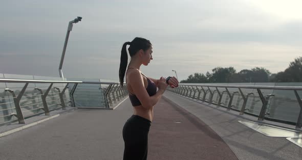 Sportswoman Checking Smart Watch During Training