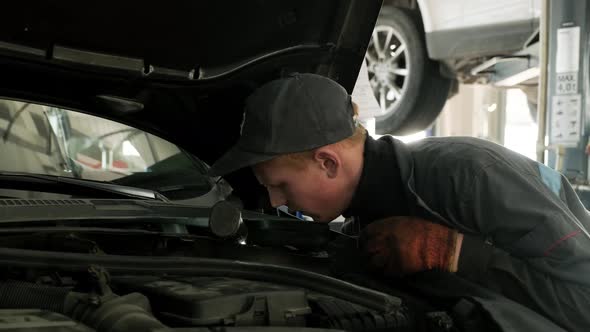 Mechanic working on a car engine