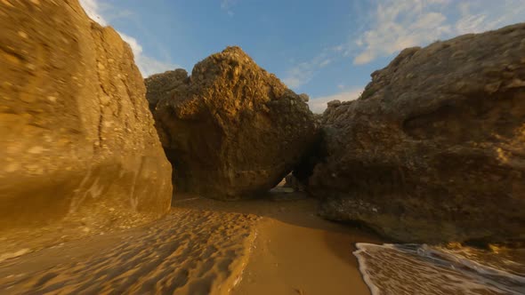 Drone Through Beach Rocks To Sea