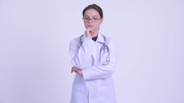 Serious Young Woman Doctor Thinking and Looking Down