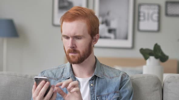 Shocked Creative Beard Man Reacting to News on Smartphone