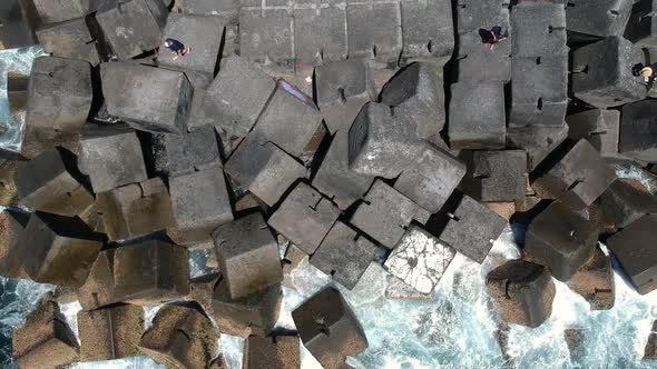 Arial view of a seaway wall created using large blocks and a navigational beacon which allow boats t