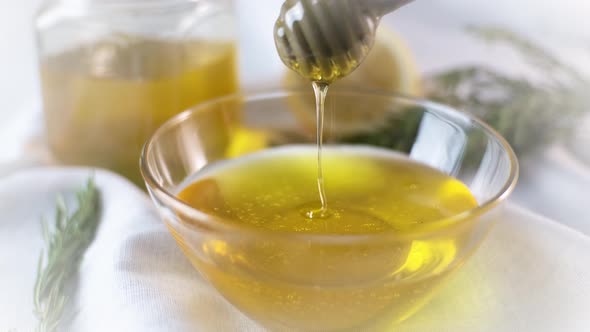 Honey Pouring in Glass Bowl