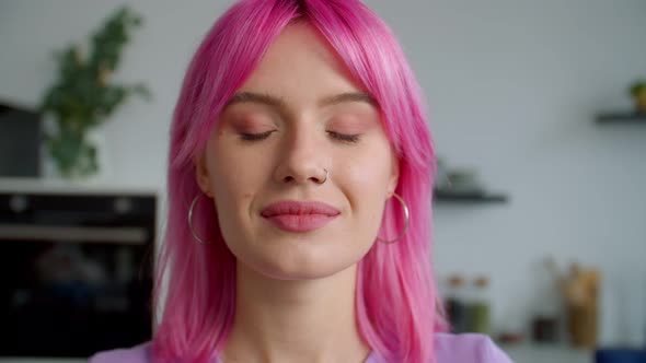 Closeup Portrait of Beautiful Pink Haired Young Woman Flirting Indoors