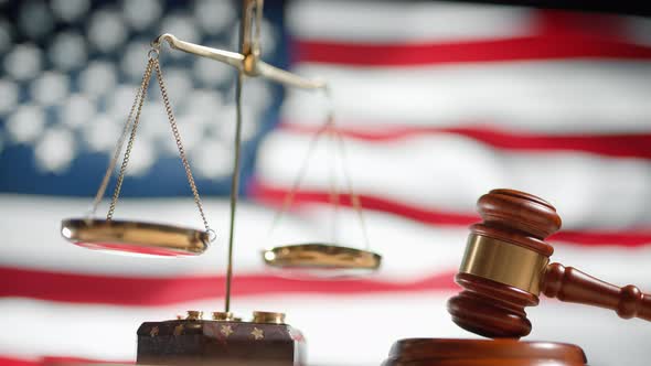 A Judge Gavel with a Flag of United States of America on Background