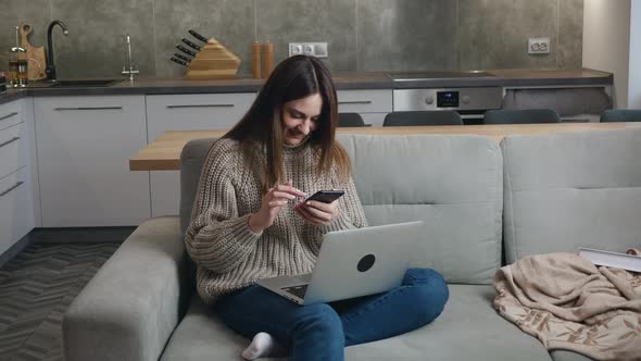 A Woman in a Woolen Sweater in Cozy Sofa  in Autumn or Winter