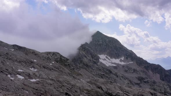 Edge of Mountain View with Clouds Snow Desolate Landscape No Human Hard Life Conditions