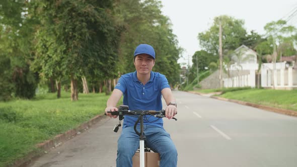 Delivery Man Rides A Electric Scooter On The Road To Deliver Orders And Packages For Customers