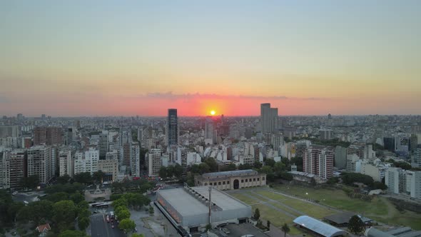 Aerial descending view overlooking Palermo district Buenos Aires urban city landscape at sunset