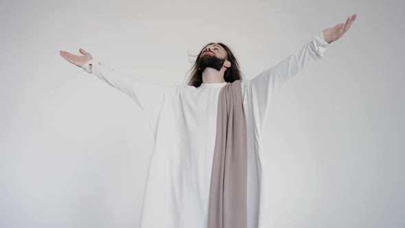 Jesus Raised His Hands and Head in Prayer on a White Background