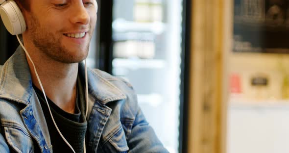 Man listening to music on digital tablet