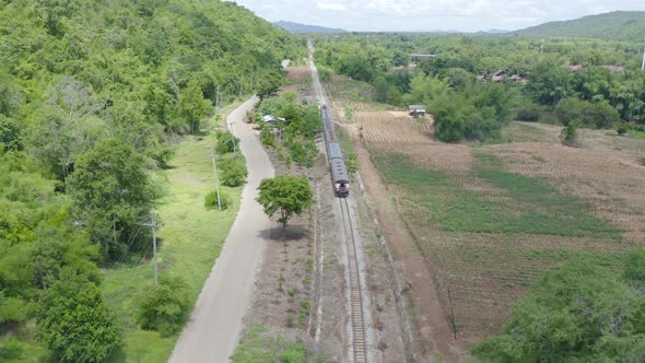 Aerial view of Thai local old classic train on railway on River Kwai Bridge