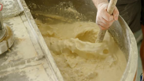 Male worker stirring gin in distillery 4k