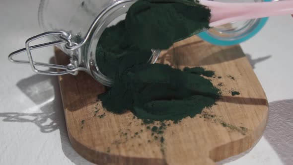 Spirulina Algae Powder on a Wooden Spoon