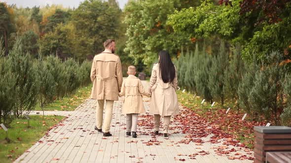 A Happy Family is Walking in the Park