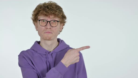 Copy Space, Redhead Young Man Pointing with Finger, White Background