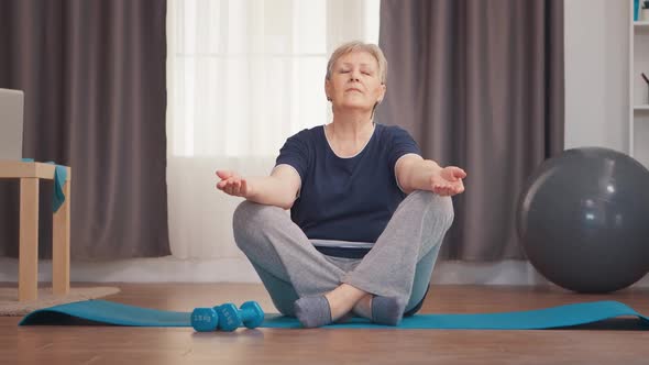 Peaceful Senior Woman Doing Yoga