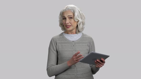 Old Senior Lady with Tablet Pc Giving Speech