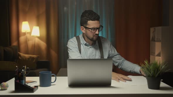 Young businessman wearing suit working with documents. Business, people, paperwork concept.